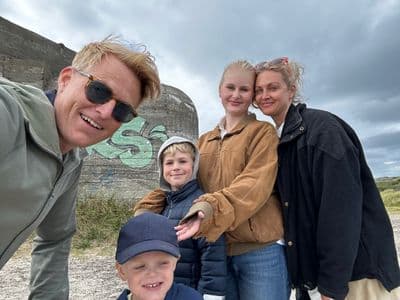Mads Nissen with wife and three children at a Scandinavian beach near a WWII bunker, casual family outing